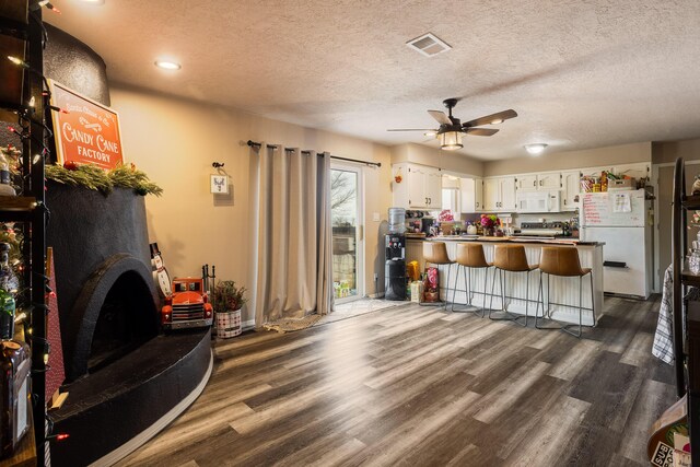 misc room with ceiling fan and dark hardwood / wood-style flooring