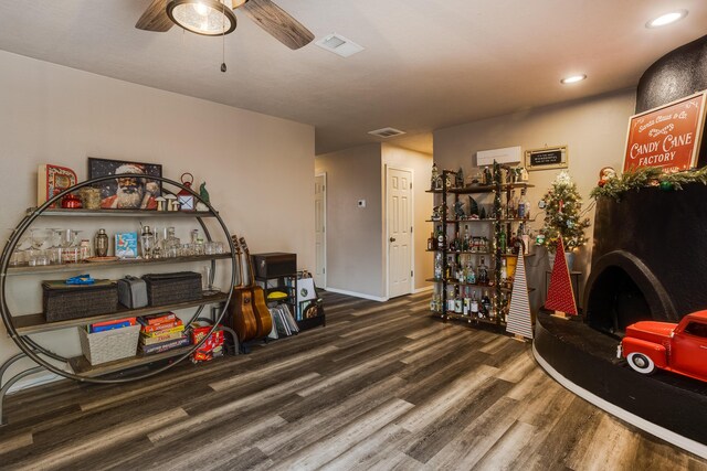 bedroom with dark hardwood / wood-style flooring, a textured ceiling, and ceiling fan