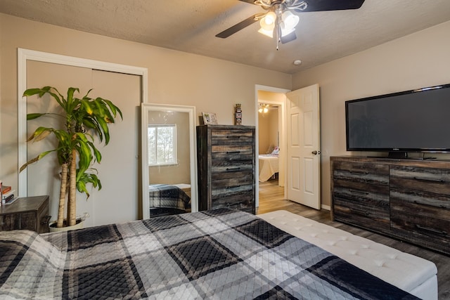 bedroom with a closet, ceiling fan, a textured ceiling, light hardwood / wood-style flooring, and ensuite bathroom