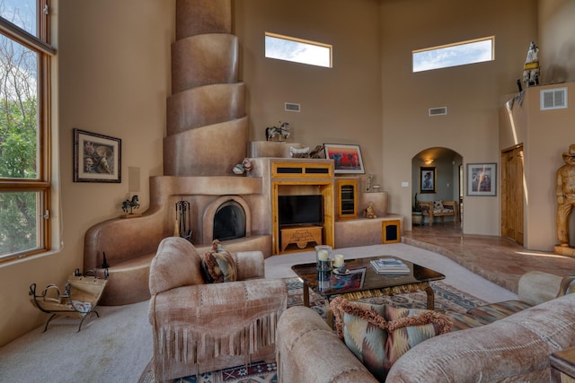 living room featuring a towering ceiling