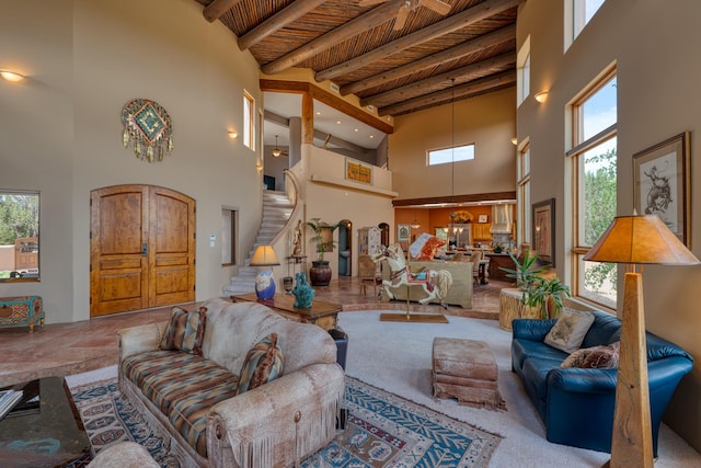 living room featuring a high ceiling and wooden ceiling