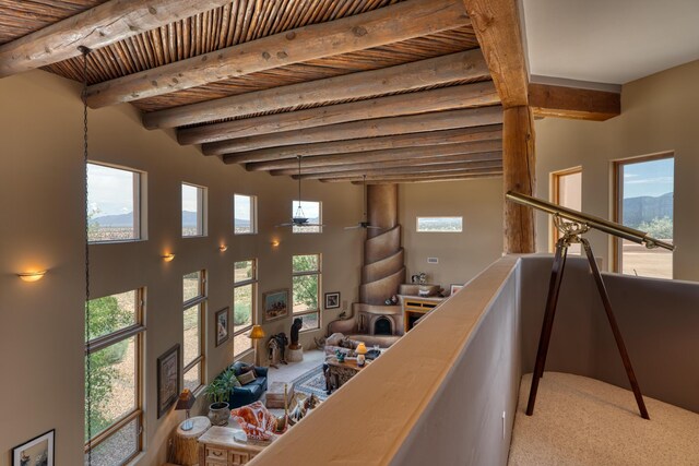 interior space featuring beamed ceiling, a fireplace, and wooden ceiling