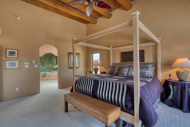 carpeted bedroom featuring ceiling fan, wood ceiling, and beamed ceiling