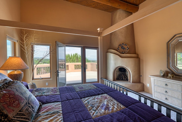 bedroom featuring wooden ceiling, multiple windows, access to outside, and beam ceiling