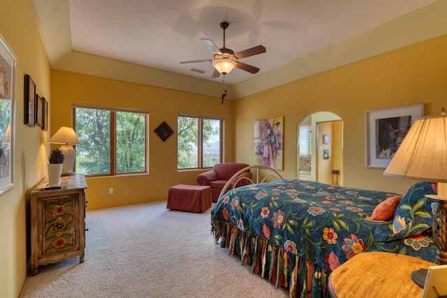 bedroom with lofted ceiling, light carpet, and ceiling fan