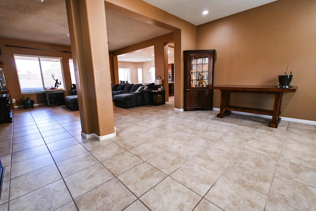 entryway with light tile patterned floors, baseboards, and recessed lighting