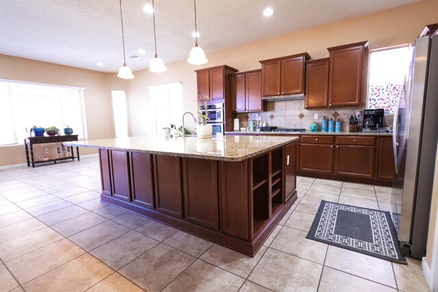 kitchen featuring open shelves, backsplash, appliances with stainless steel finishes, light tile patterned flooring, and light stone countertops