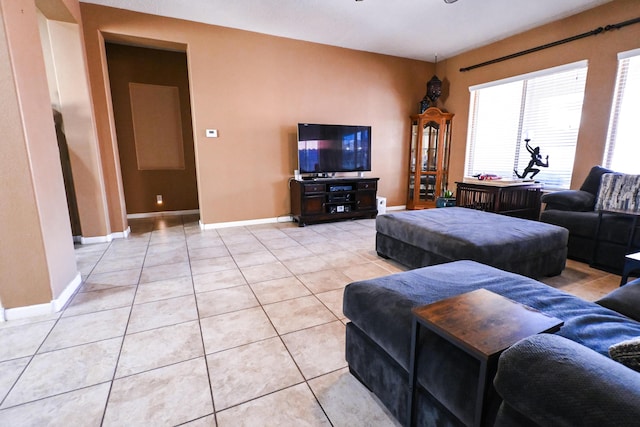 living room with light tile patterned floors and baseboards