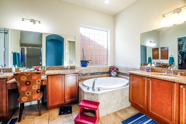 bathroom featuring a garden tub, tile patterned floors, a sink, and a shower stall