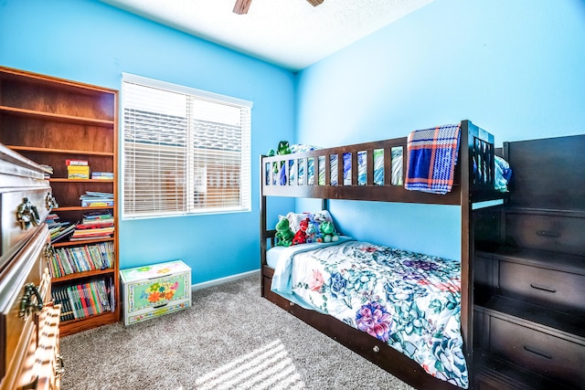 bedroom featuring a ceiling fan, carpet, and baseboards