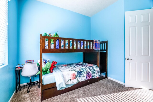 bedroom with carpet floors and baseboards