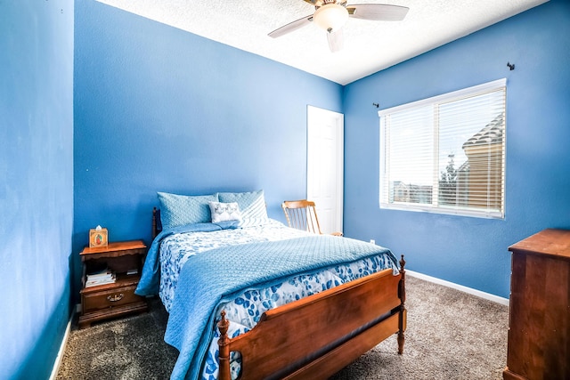 carpeted bedroom with ceiling fan and baseboards