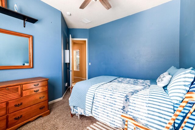 carpeted bedroom featuring ceiling fan and baseboards