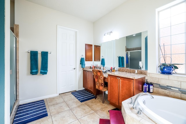 bathroom with baseboards, tile patterned floors, a garden tub, vanity, and a shower stall