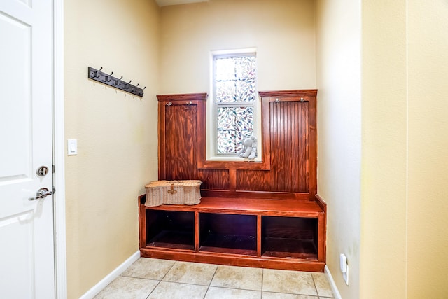 mudroom featuring light tile patterned floors and baseboards