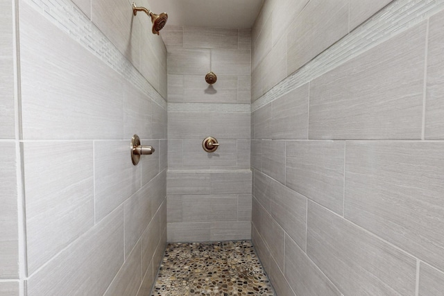 bathroom with a tile shower