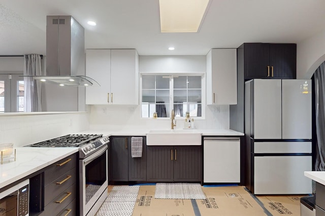 kitchen with sink, island range hood, stainless steel appliances, and white cabinetry