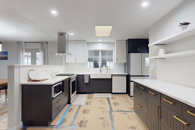 kitchen with white cabinets, dishwasher, sink, island range hood, and stainless steel gas range oven