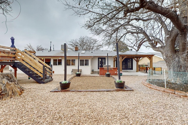 back of property featuring a patio area, a jacuzzi, and a gazebo