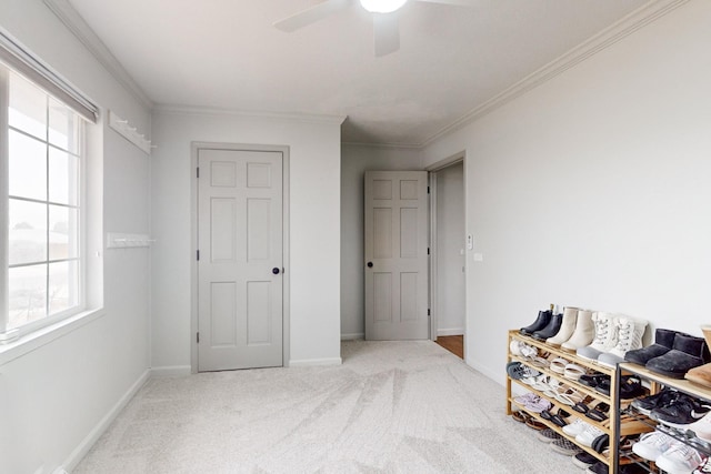 carpeted bedroom with ceiling fan and ornamental molding