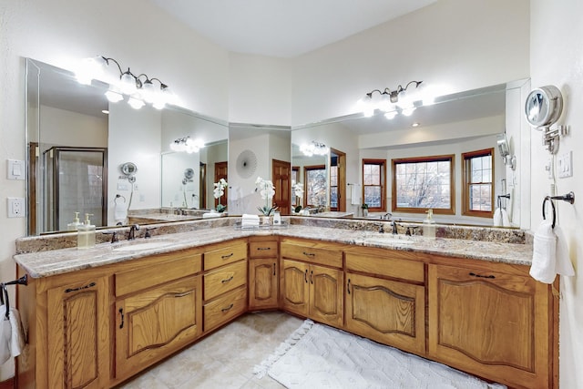 bathroom featuring a shower with door, tile patterned flooring, and vanity