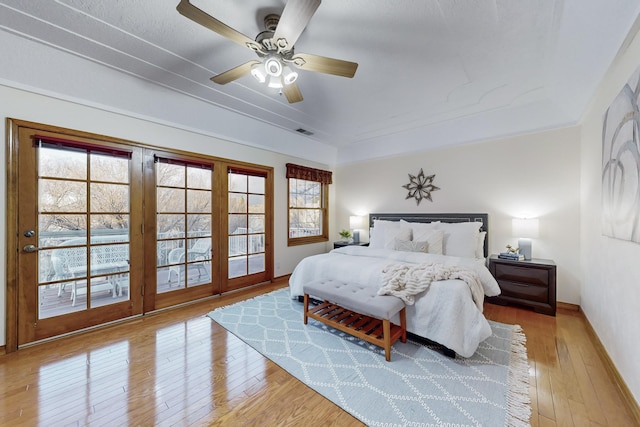 bedroom with french doors, ceiling fan, access to outside, and light hardwood / wood-style flooring