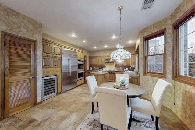 dining space with sink and beverage cooler