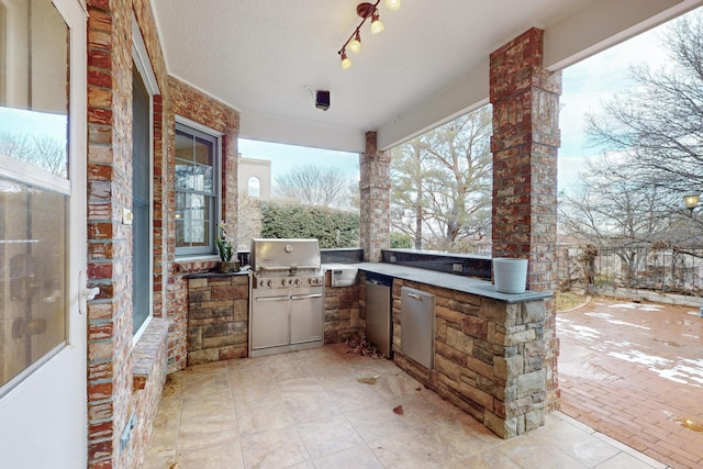 view of patio with an outdoor kitchen and a grill