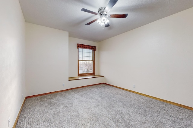 unfurnished room with ceiling fan and carpet