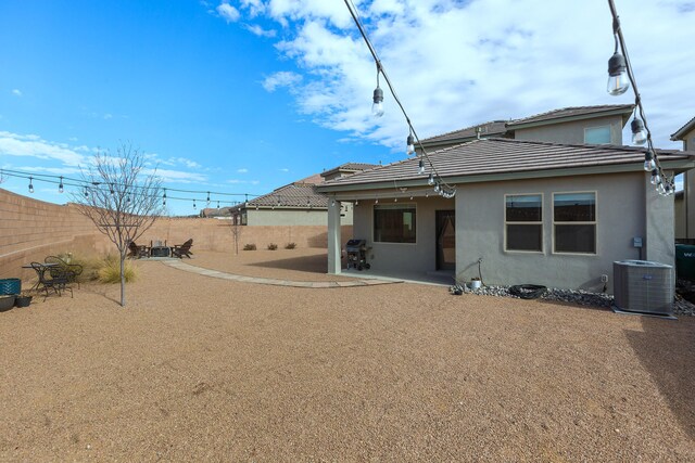 rear view of house featuring a patio area and central AC unit