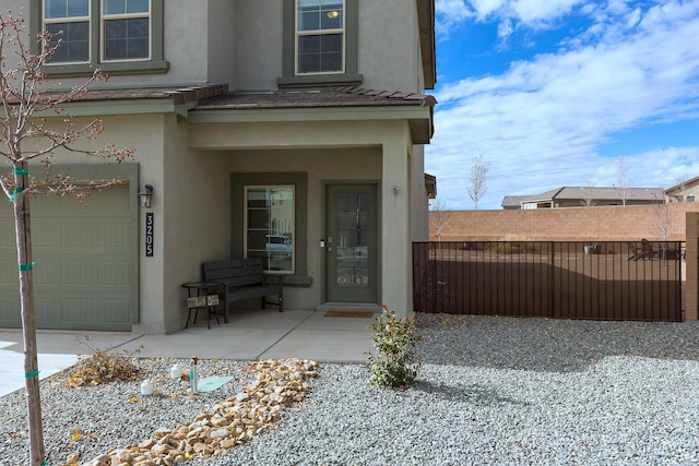 view of exterior entry featuring a garage