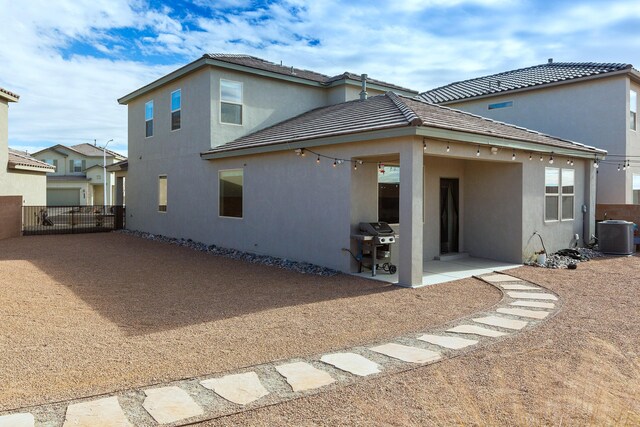 rear view of house with a patio and central AC