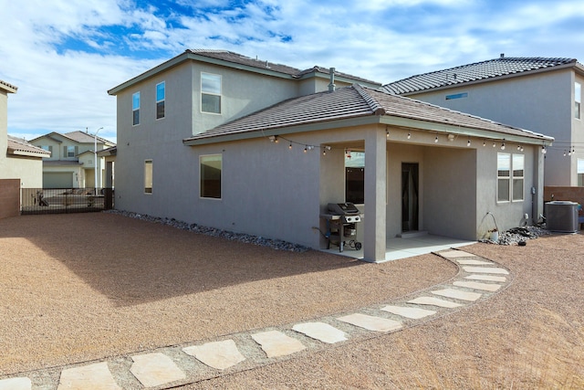 back of house with central air condition unit and a patio area