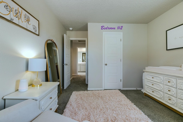 bedroom featuring a textured ceiling and dark colored carpet
