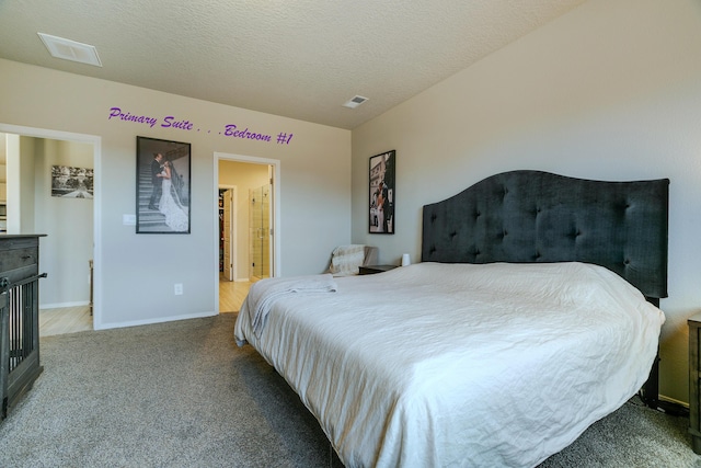 bedroom featuring a textured ceiling and light carpet