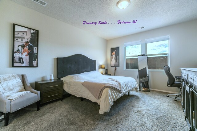 bedroom featuring a textured ceiling and carpet floors