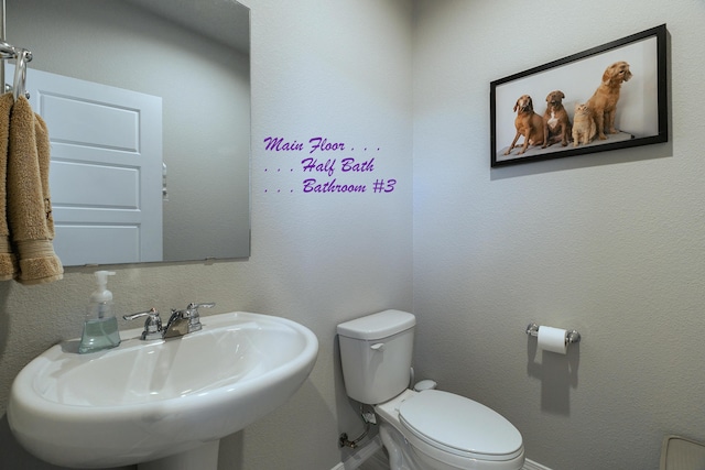 bathroom featuring sink and toilet