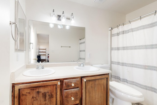 bathroom featuring toilet and vanity