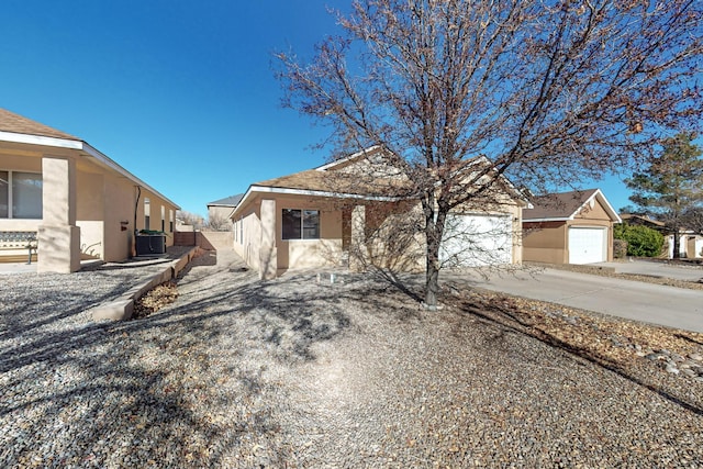 view of front of home with a garage and cooling unit