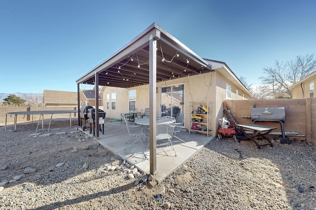 view of patio / terrace with a grill and a trampoline