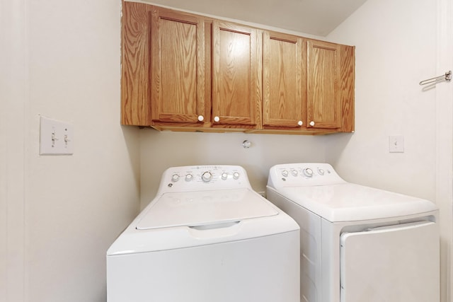 laundry room featuring cabinets and washing machine and clothes dryer