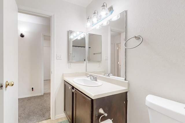 bathroom with toilet and vanity