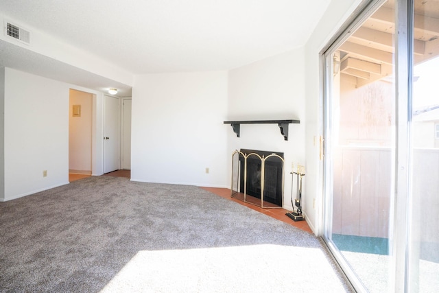 unfurnished living room featuring carpet floors