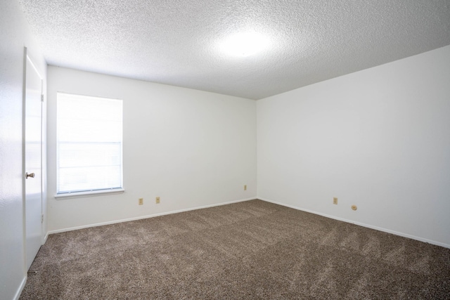 carpeted spare room featuring a textured ceiling