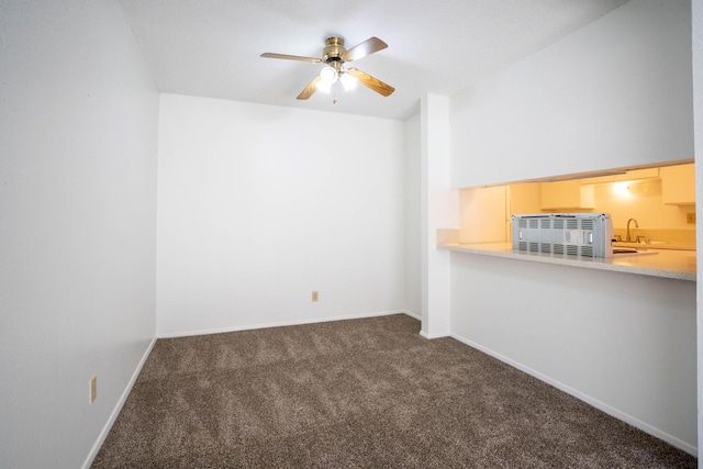 carpeted spare room with sink and ceiling fan