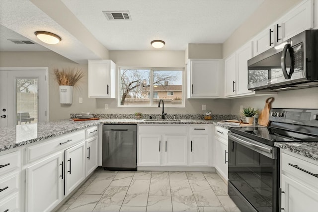 kitchen featuring sink, white cabinets, dishwasher, and range with electric stovetop