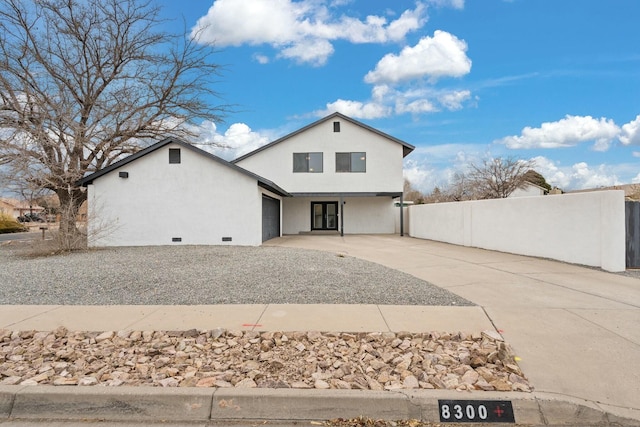 rear view of house featuring a garage