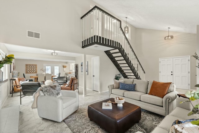 living room featuring a towering ceiling