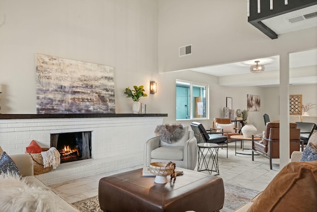 living room with a brick fireplace