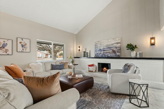 living room with a brick fireplace and high vaulted ceiling